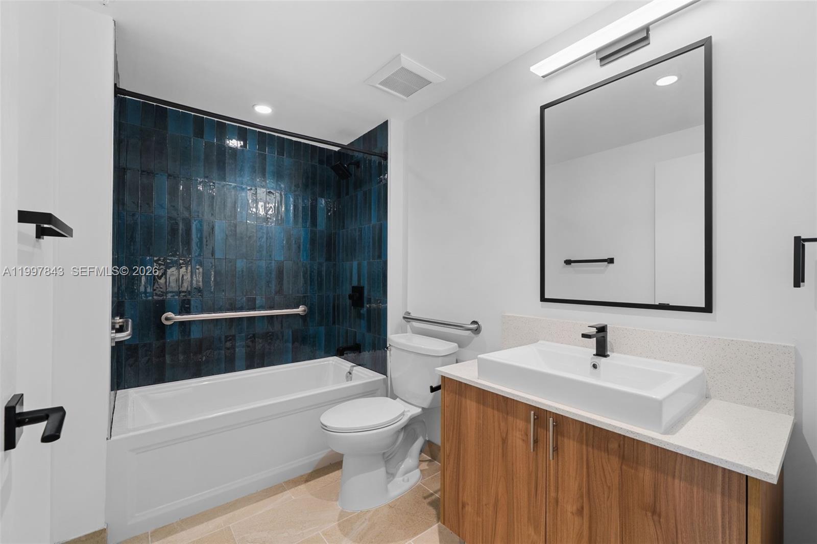 650 Southwest 1st Street, Unit 304 Miami, FL 33130 - Photo 10 of 16 a bathroom with a sink a toilet and shower
