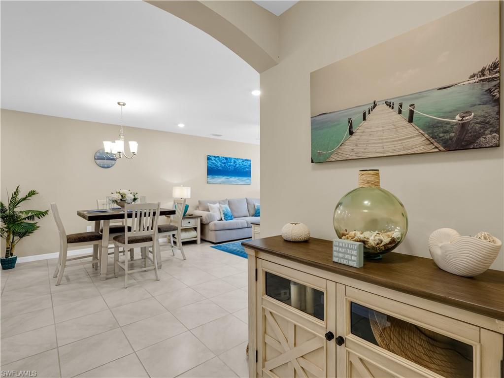 14695 Edgewater Circle Naples, FL 34114 - Photo 4 of 39 a kitchen with a table and chairs