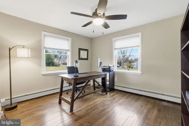 a workspace with wooden floor and a window