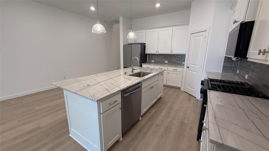 2805 Concord Drive Wylie, TX 75098 - Photo 3 of 19 a kitchen with a stove sink and a refrigerator