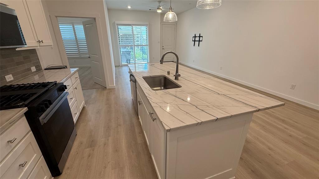 2805 Concord Drive Wylie, TX 75098 - Photo 6 of 19 a kitchen with a sink a stove and cabinets