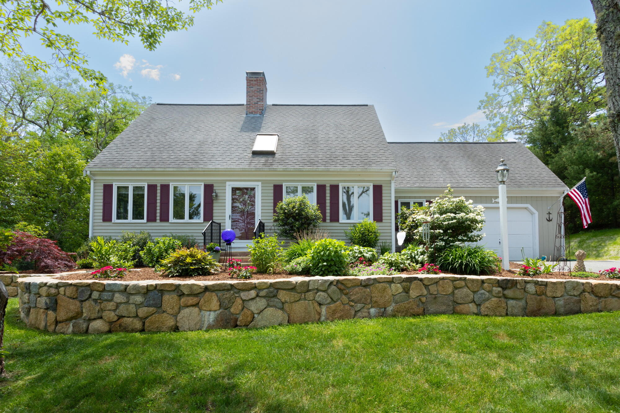a front view of house with a yard and potted plants