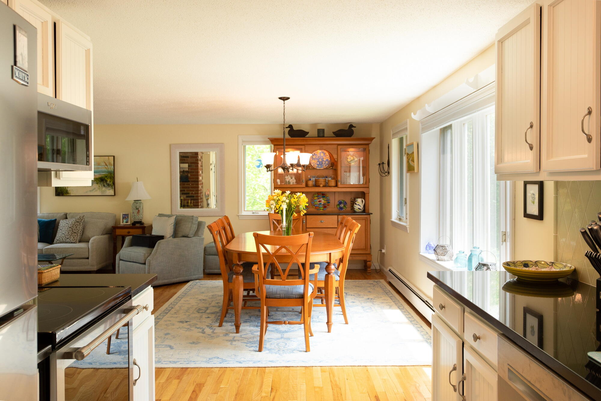 21 Captain Isiah's Road Cotuit, MA 02635 - Photo 13 of 47 a dining room with furniture a chandelier and wooden floor