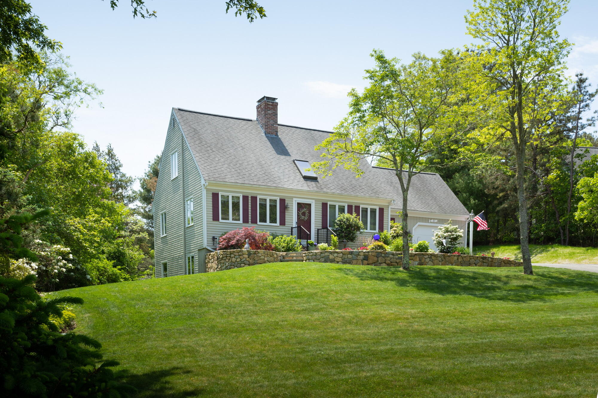 21 Captain Isiah's Road Cotuit, MA 02635 - Photo 2 of 47 a front view of a house with a garden