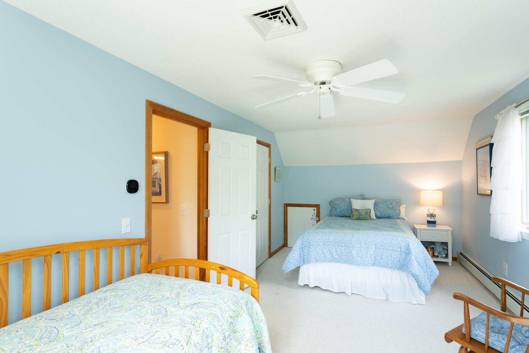 21 Captain Isiah's Road Cotuit, MA 02635 - Photo 23 of 47 a bedroom with a bed and a chandelier