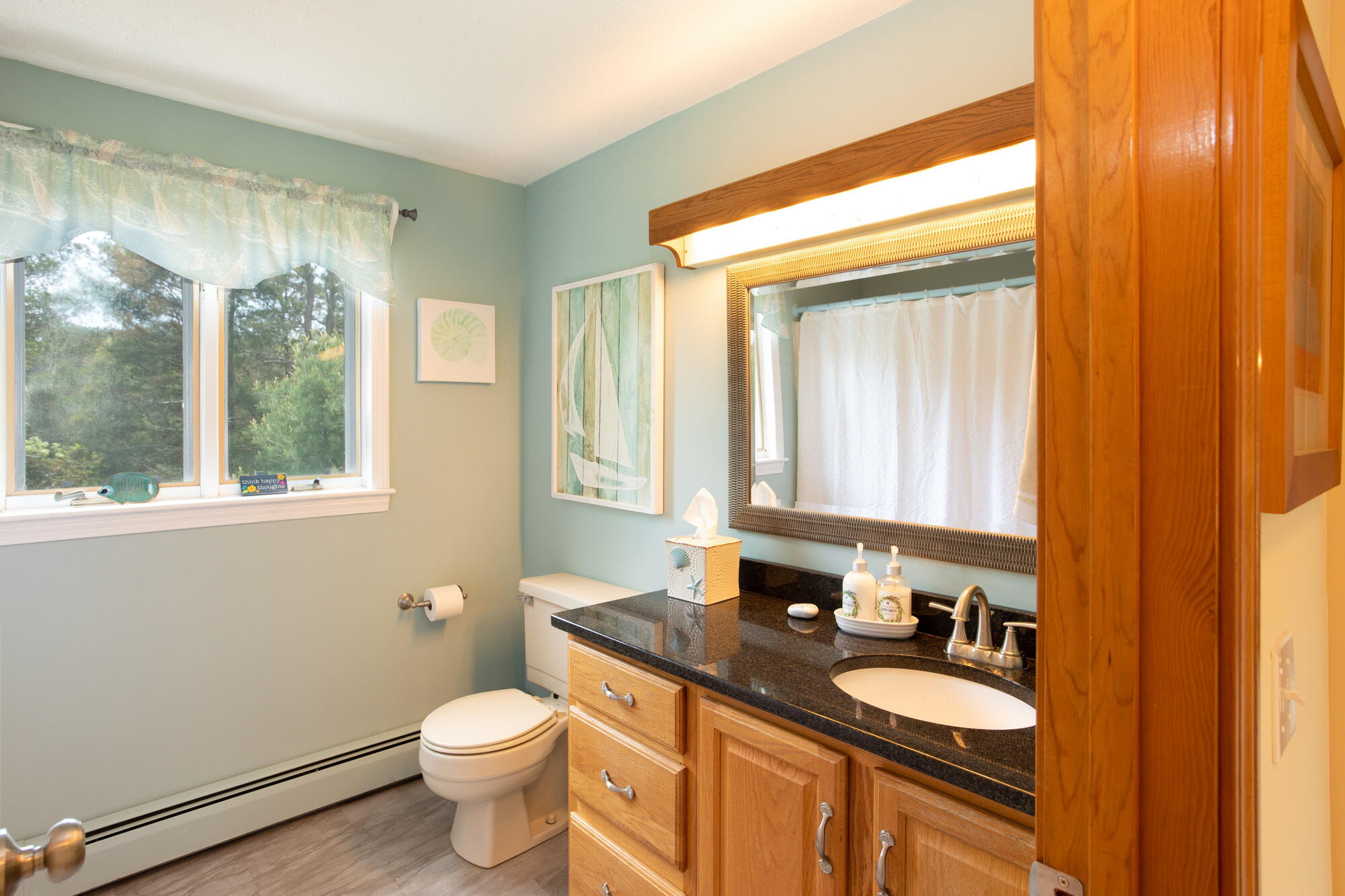 21 Captain Isiah's Road Cotuit, MA 02635 - Photo 24 of 47 a bathroom with a granite countertop toilet a sink a mirror and a window