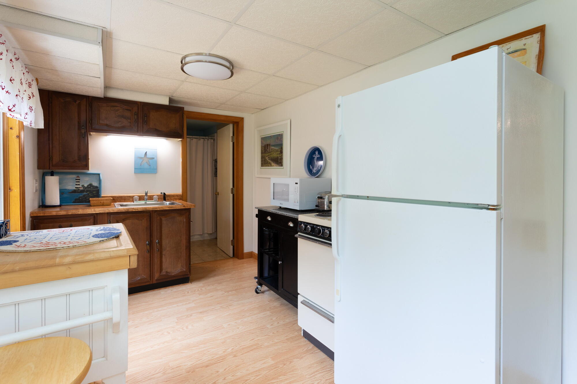 21 Captain Isiah's Road Cotuit, MA 02635 - Photo 31 of 47 a kitchen with a refrigerator and a sink