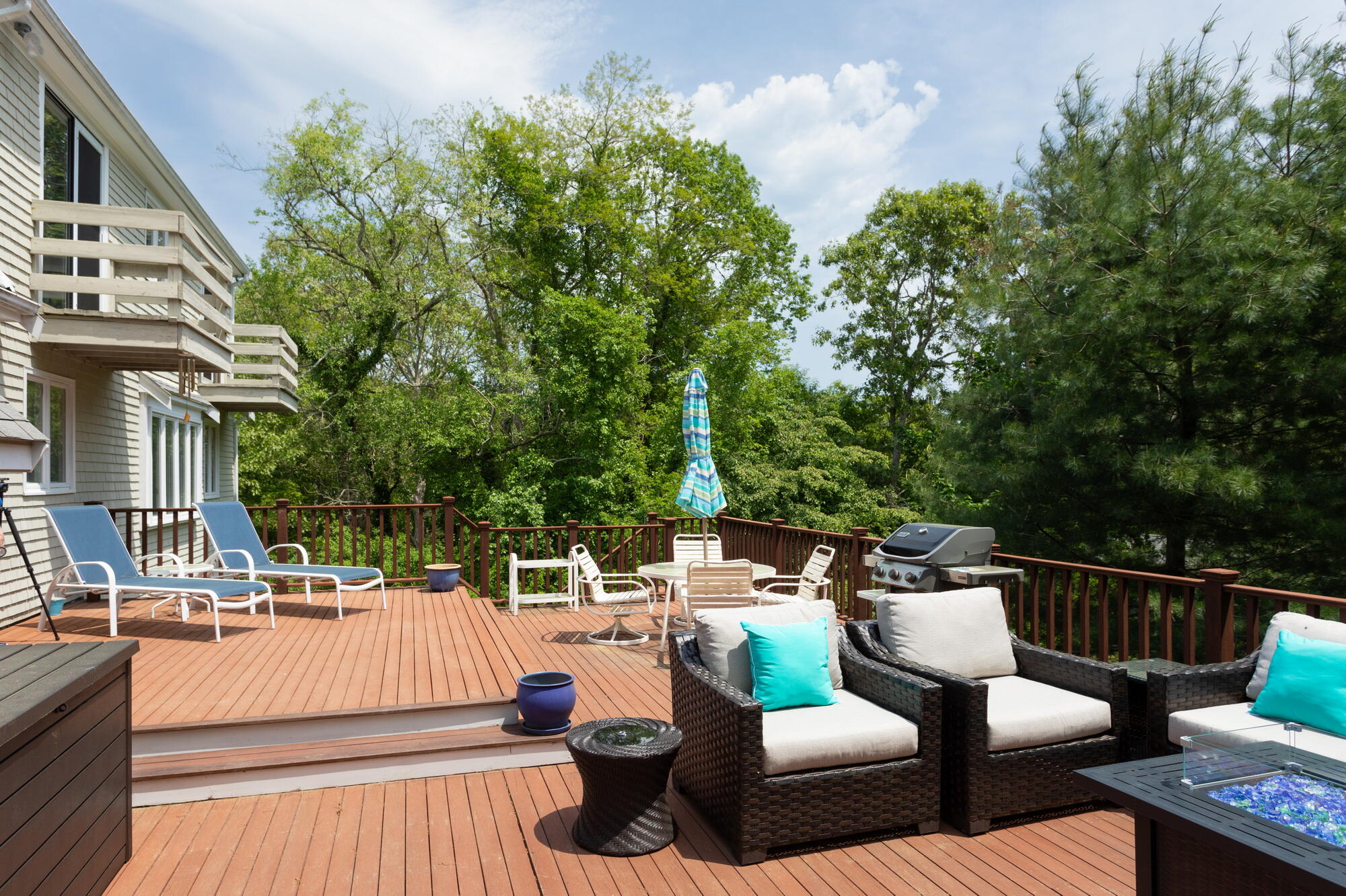 21 Captain Isiah's Road Cotuit, MA 02635 - Photo 34 of 47 a view of a patio with couches table and chairs and potted plants