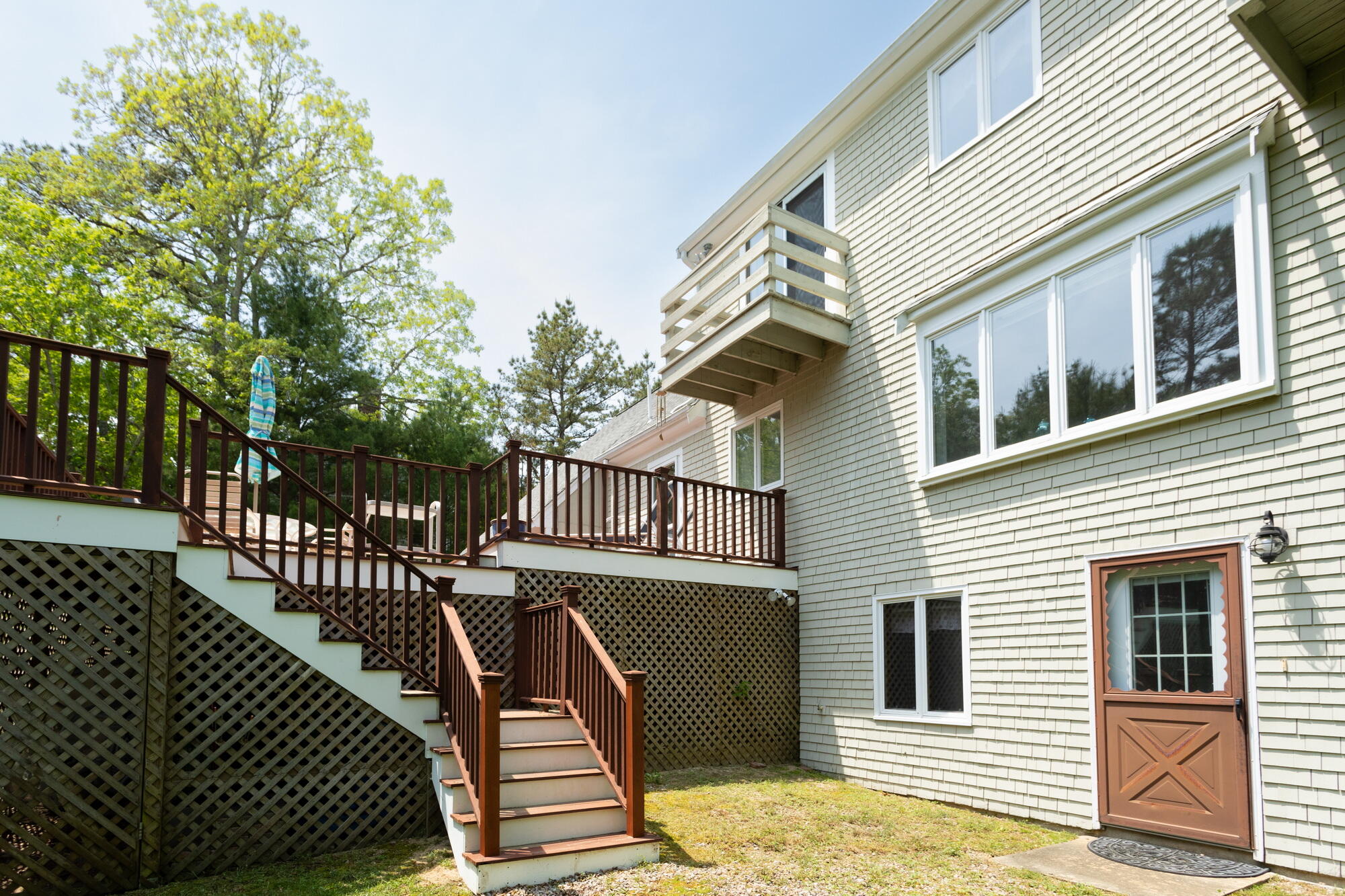 21 Captain Isiah's Road Cotuit, MA 02635 - Photo 36 of 47 a view of a brick house with large windows
