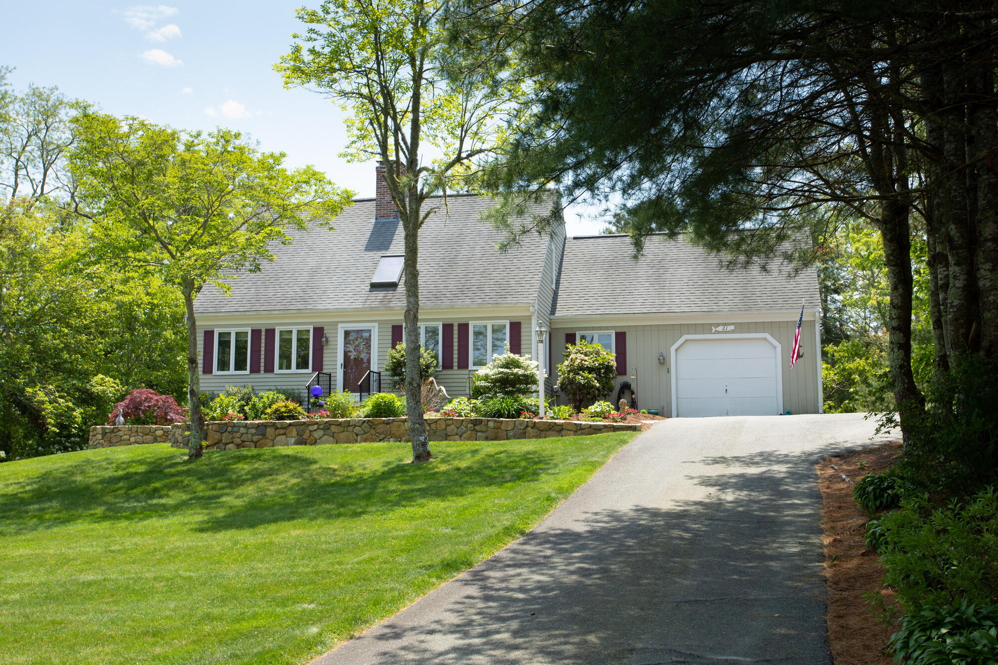 21 Captain Isiah's Road Cotuit, MA 02635 - Photo 4 of 47 a front view of a house with a yard and trees