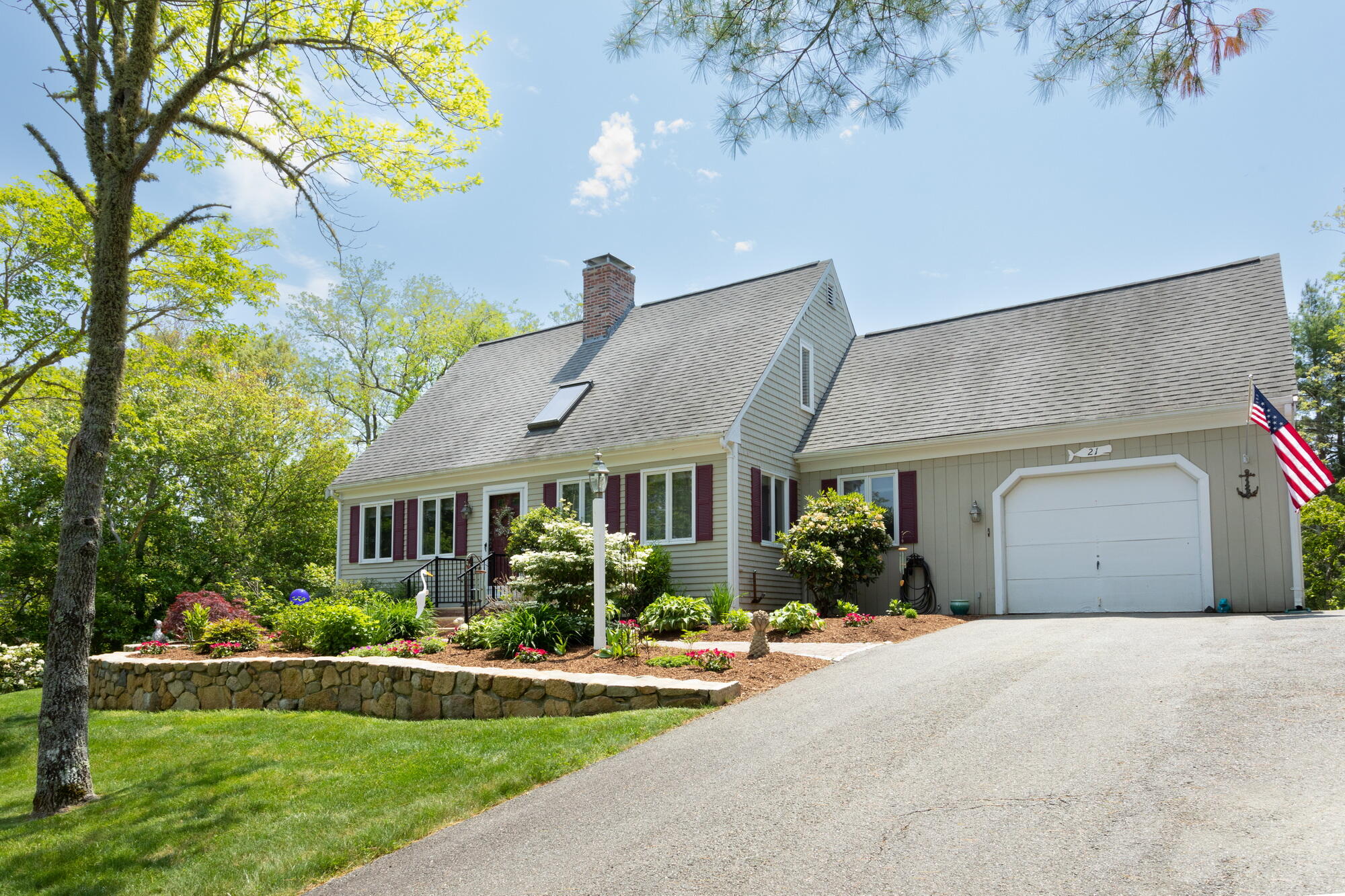 21 Captain Isiah's Road Cotuit, MA 02635 - Photo 6 of 47 a front view of a house with a yard and garage