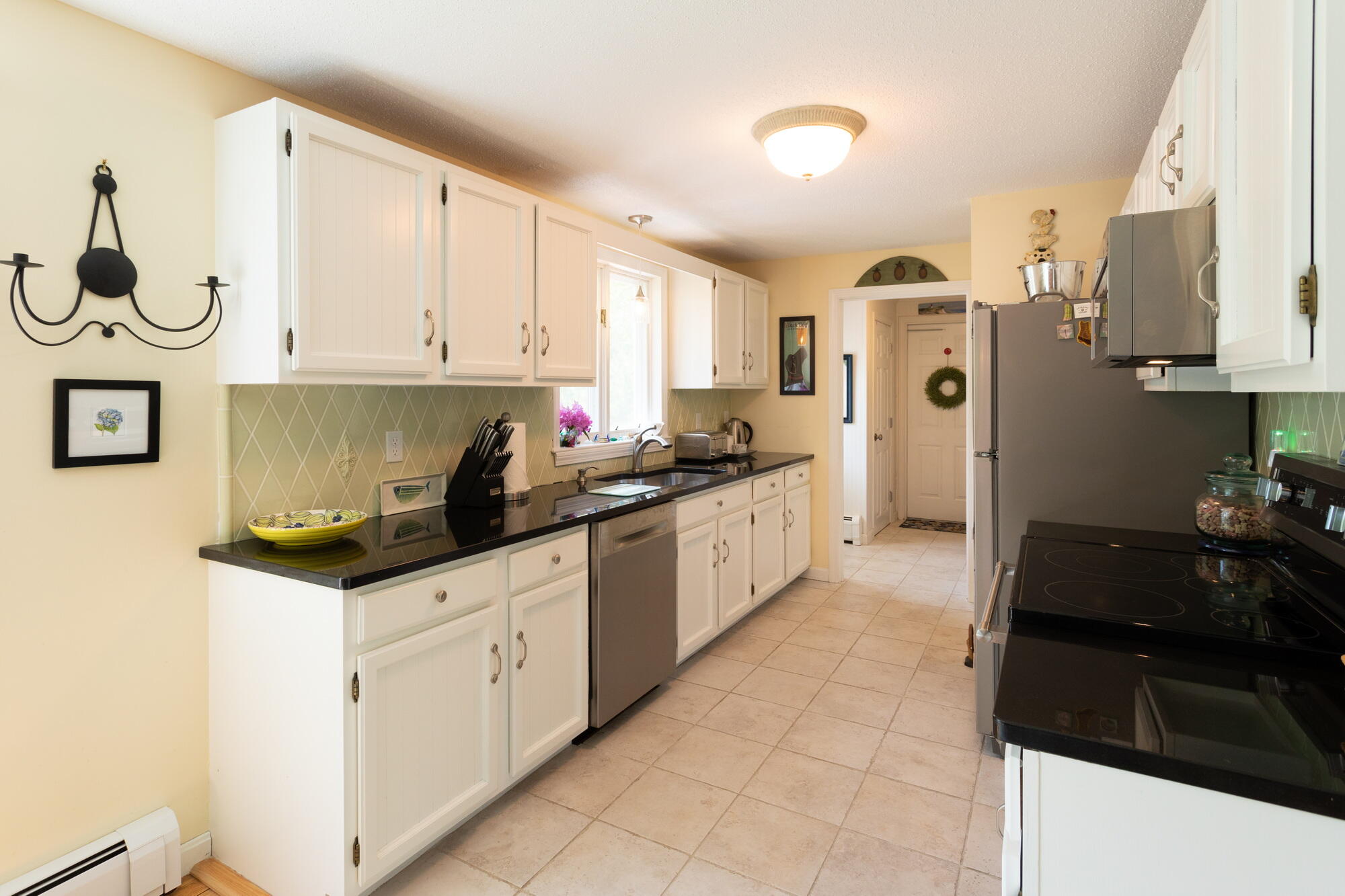 21 Captain Isiah's Road Cotuit, MA 02635 - Photo 10 of 47 a kitchen with granite countertop a sink and a stove top oven
