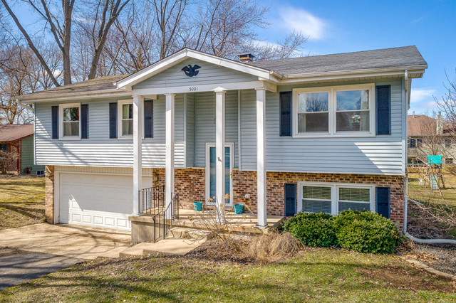5001 Tile Line Road Crystal Lake, IL 60012 - Photo 1 of 30 a front view of a house with a yard and garage