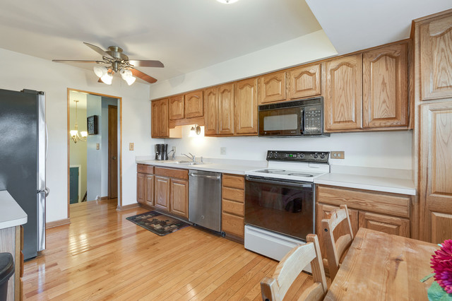5001 Tile Line Road Crystal Lake, IL 60012 - Photo 12 of 30 a kitchen with granite countertop a stove a sink and a refrigerator