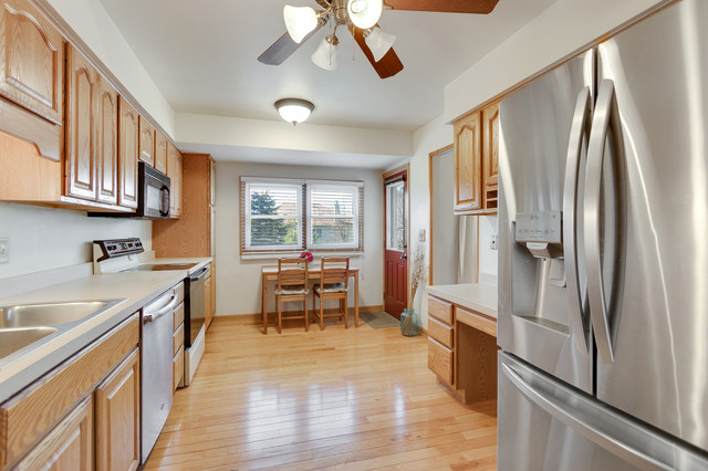 5001 Tile Line Road Crystal Lake, IL 60012 - Photo 14 of 30 a kitchen with stainless steel appliances granite countertop a refrigerator a sink dishwasher a stove and white countertops with wooden floor