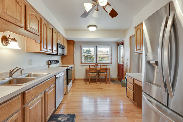 5001 Tile Line Road Crystal Lake, IL 60012 - Photo 10 of 30 a kitchen with stainless steel appliances granite countertop a refrigerator a sink a stove and a wooden floors