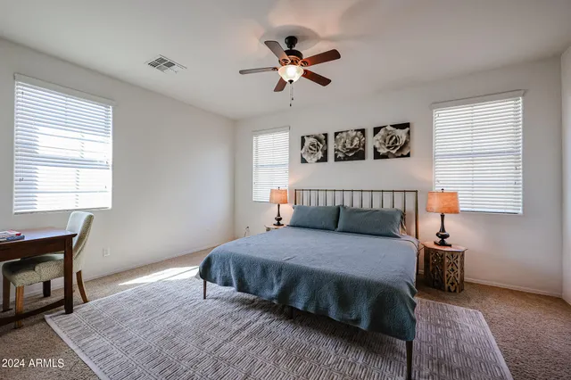 a bedroom with a bed and a chair