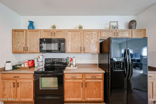 a kitchen with stainless steel appliances granite countertop a refrigerator and a stove top oven
