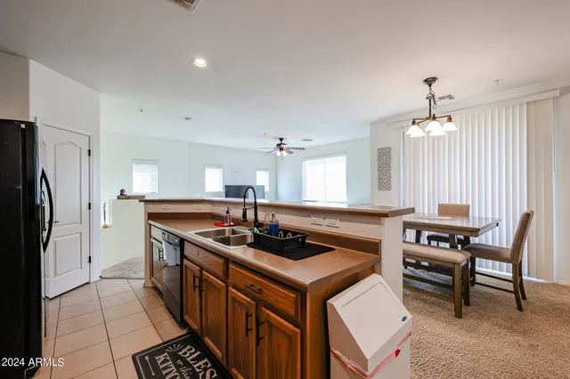 a kitchen with stainless steel appliances granite countertop a stove a refrigerator and a dining table