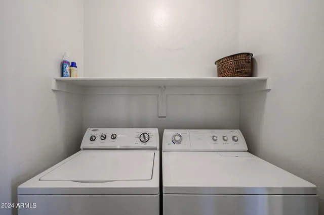 a bedroom with a bed and a chandelier fan