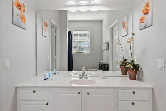 a bedroom with a bed and a flat tv screen on dresser