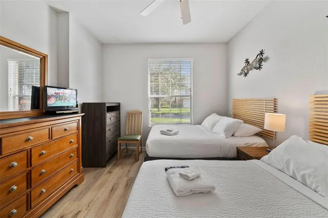 a bedroom with two beds and a chandelier