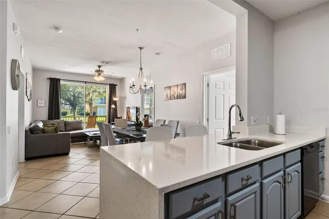 a kitchen with a sink and living room view