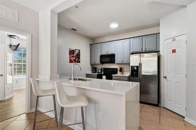 a kitchen with a refrigerator a stove a microwave oven a sink dishwasher and a refrigerator with wooden floor