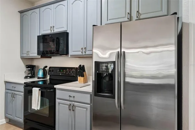 a kitchen with a refrigerator and a stove