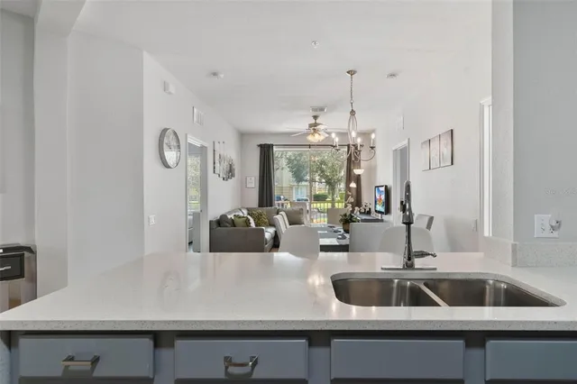a view of a kitchen area with sink and natural light
