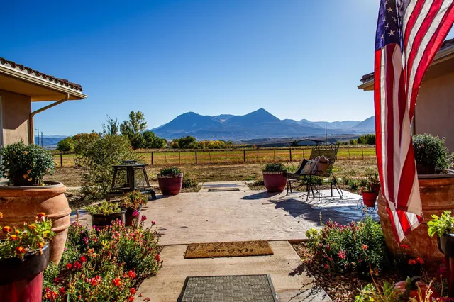 an aerial view of a house with garden space and street view