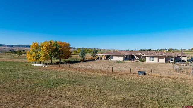 a view of a livingroom with furniture and a hallway