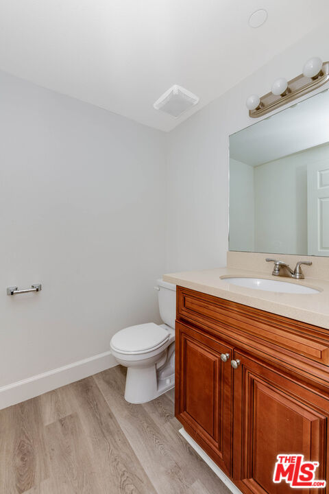 14735 Friar Street, Unit 104 Van Nuys, CA 91411 - Photo 7 of 16 a bathroom with a sink a toilet and a mirror