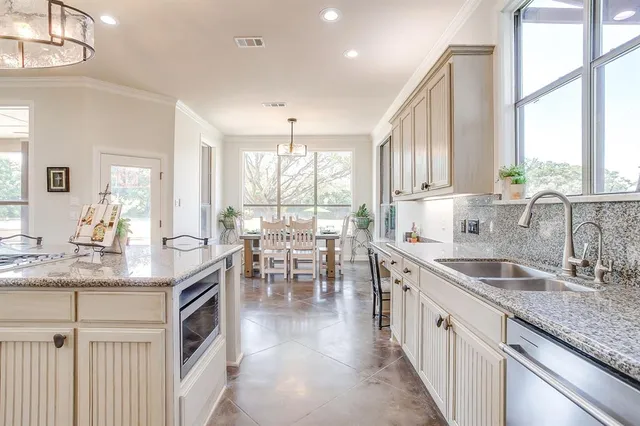a kitchen with counter top space a sink cabinets and appliances