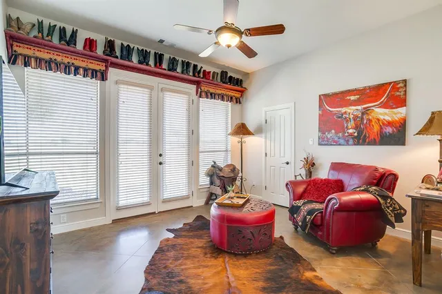a living room with furniture a rug and a window