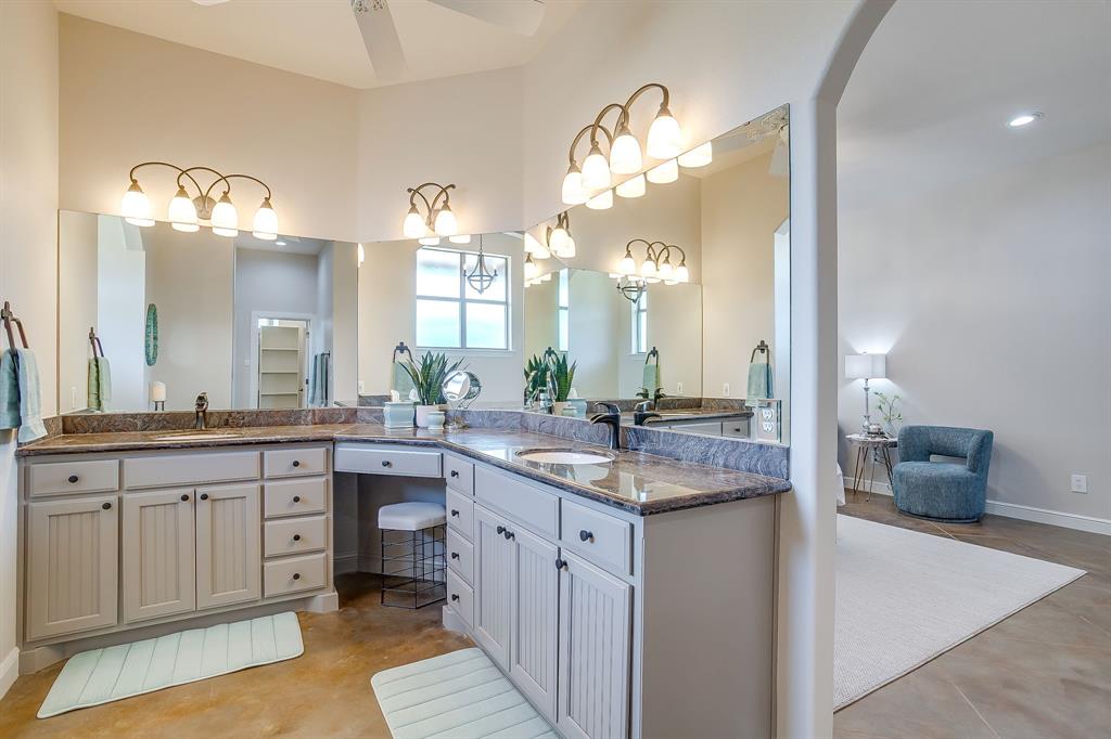 4991 Old Millsap Road Millsap, TX 76066 - Photo 19 of 40 a spacious bathroom with a granite countertop sink a mirror and a