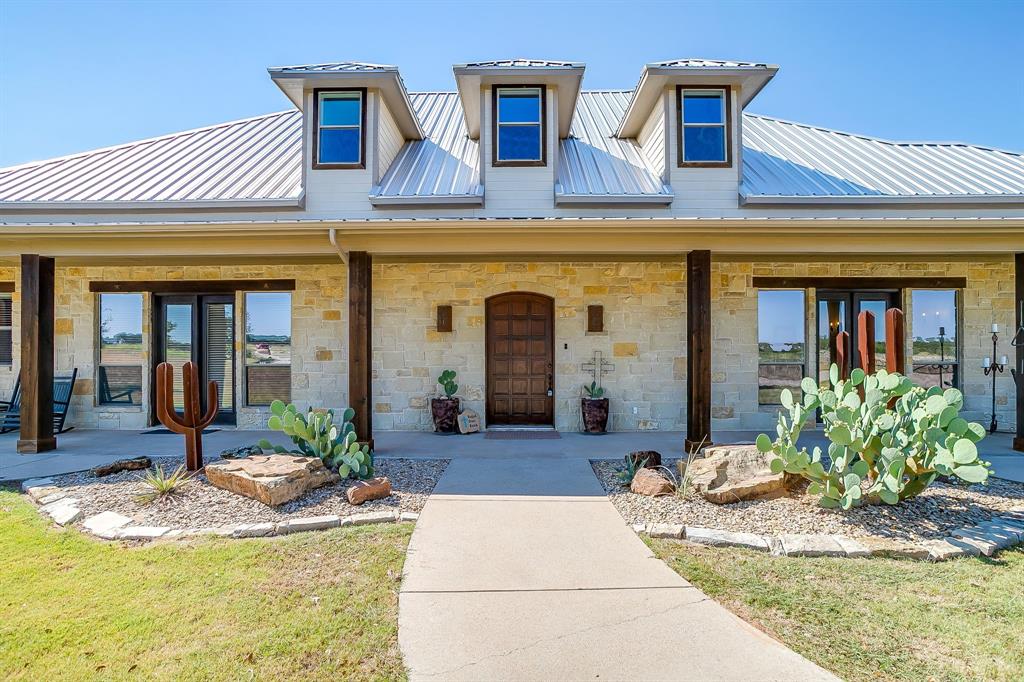 4991 Old Millsap Road Millsap, TX 76066 - Photo 4 of 40 a front view of a house with swimming pool