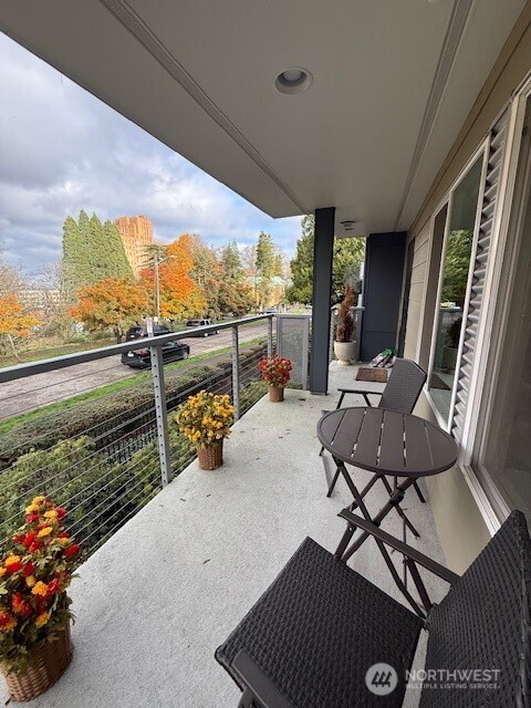 1311 12th Avenue South, Unit D301 Seattle, WA 98144 - Photo 1 of 12 a view of a chairs and table in patio with a yard