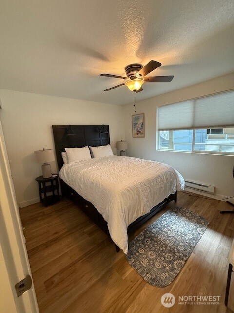 1311 12th Avenue South, Unit D301 Seattle, WA 98144 - Photo 11 of 12 a bedroom with a bed and a chandelier