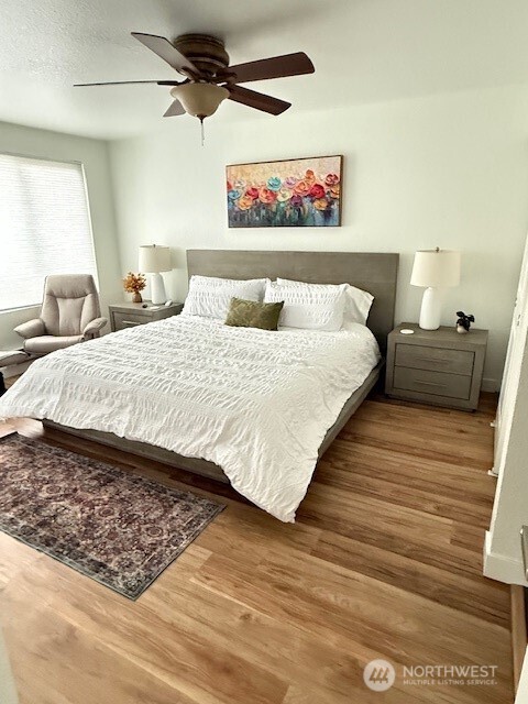 1311 12th Avenue South, Unit D301 Seattle, WA 98144 - Photo 12 of 12 a large bed sitting in a bedroom next to a cabinet