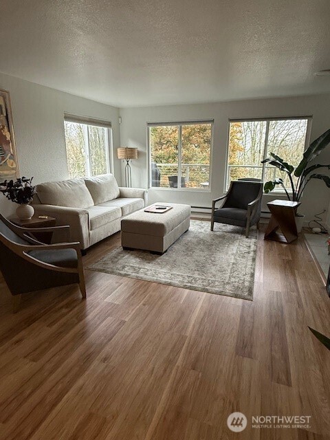 1311 12th Avenue South, Unit D301 Seattle, WA 98144 - Photo 2 of 12 a living room with furniture and a large window