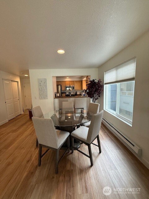 1311 12th Avenue South, Unit D301 Seattle, WA 98144 - Photo 10 of 12 a dining room with furniture and wooden floor