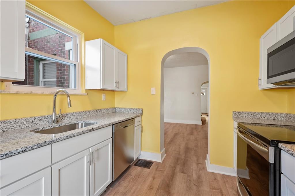 8 Edith Place Pittsburgh, PA 15213 - Photo 11 of 24 a kitchen with granite countertop a sink stainless steel appliances and cabinets