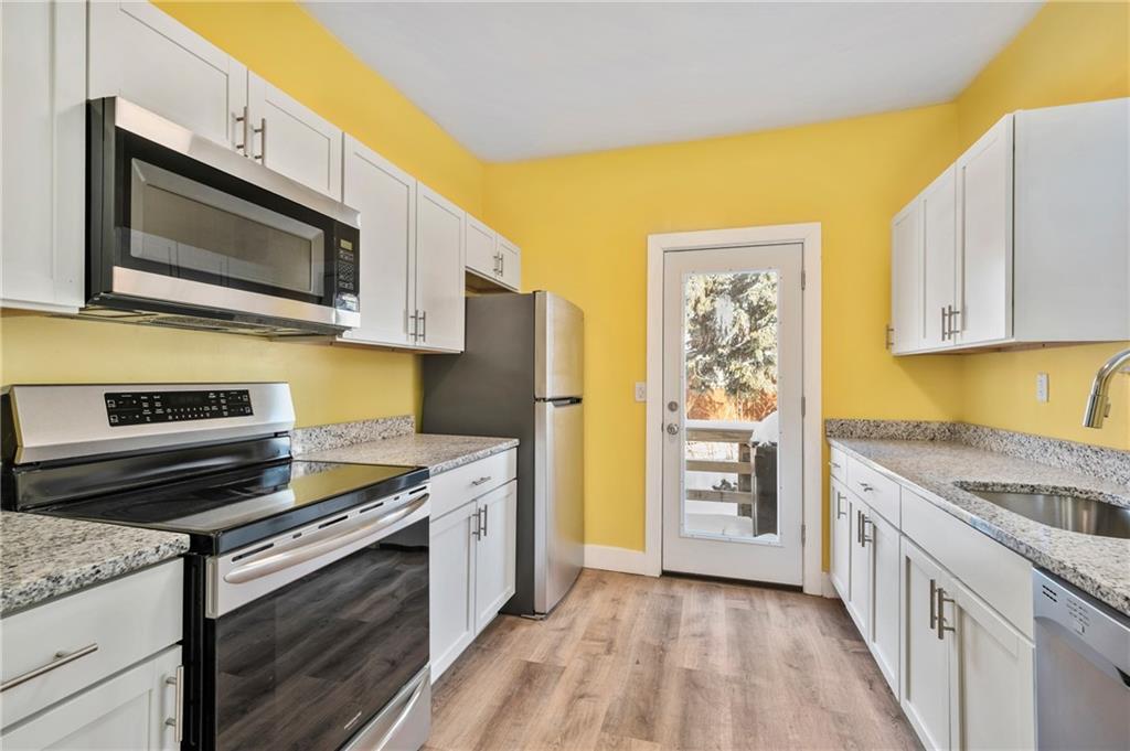 8 Edith Place Pittsburgh, PA 15213 - Photo 5 of 24 a kitchen with stainless steel appliances granite countertop a stove microwave and refrigerator