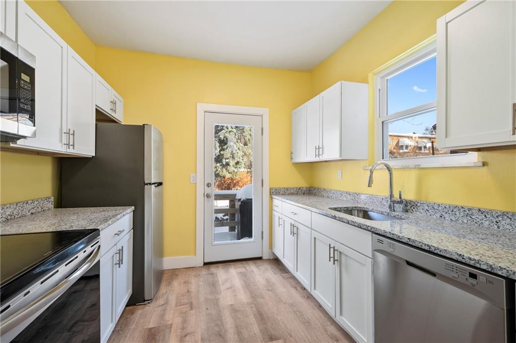 8 Edith Place Pittsburgh, PA 15213 - Photo 6 of 24 a kitchen with stainless steel appliances granite countertop a sink stove and refrigerator