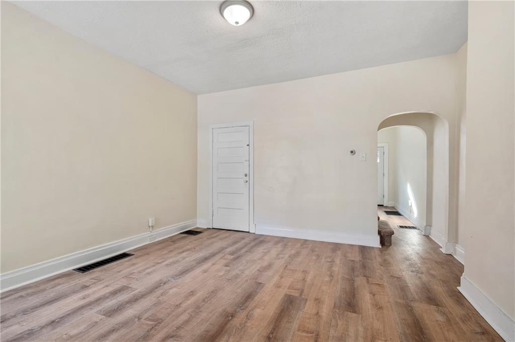 8 Edith Place Pittsburgh, PA 15213 - Photo 9 of 24 an empty room with wooden floor and mirror