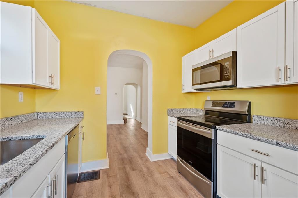 8 Edith Place Pittsburgh, PA 15213 - Photo 10 of 24 a kitchen with stainless steel appliances granite countertop a stove a sink and a microwave