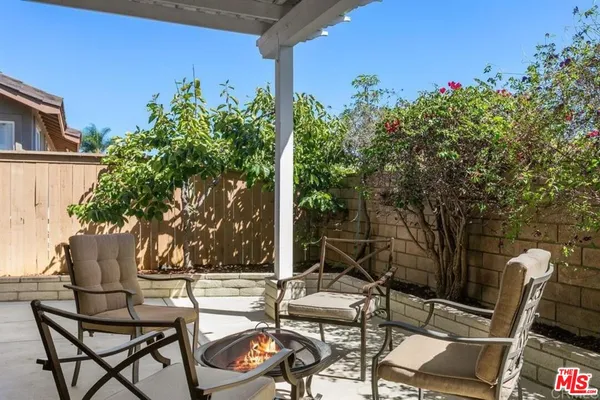 a view of a chairs and table in patio