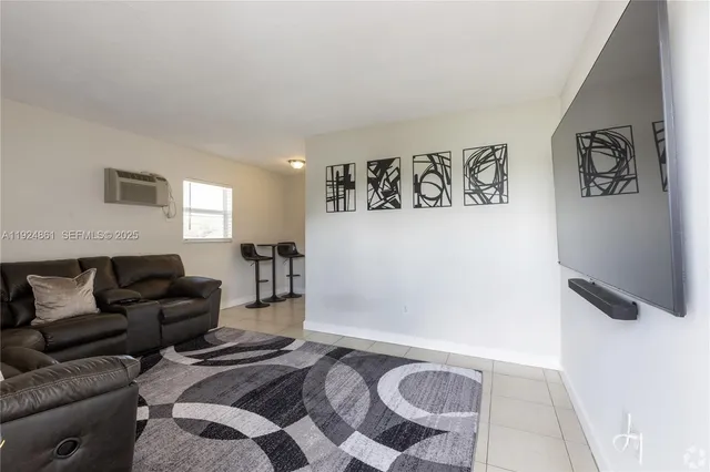 a living room with furniture and a rug
