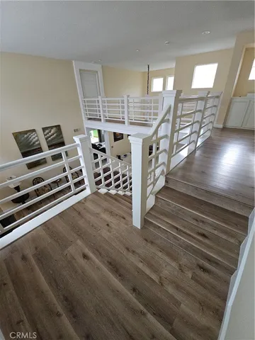 a view of a room with wooden floor staircase and windows
